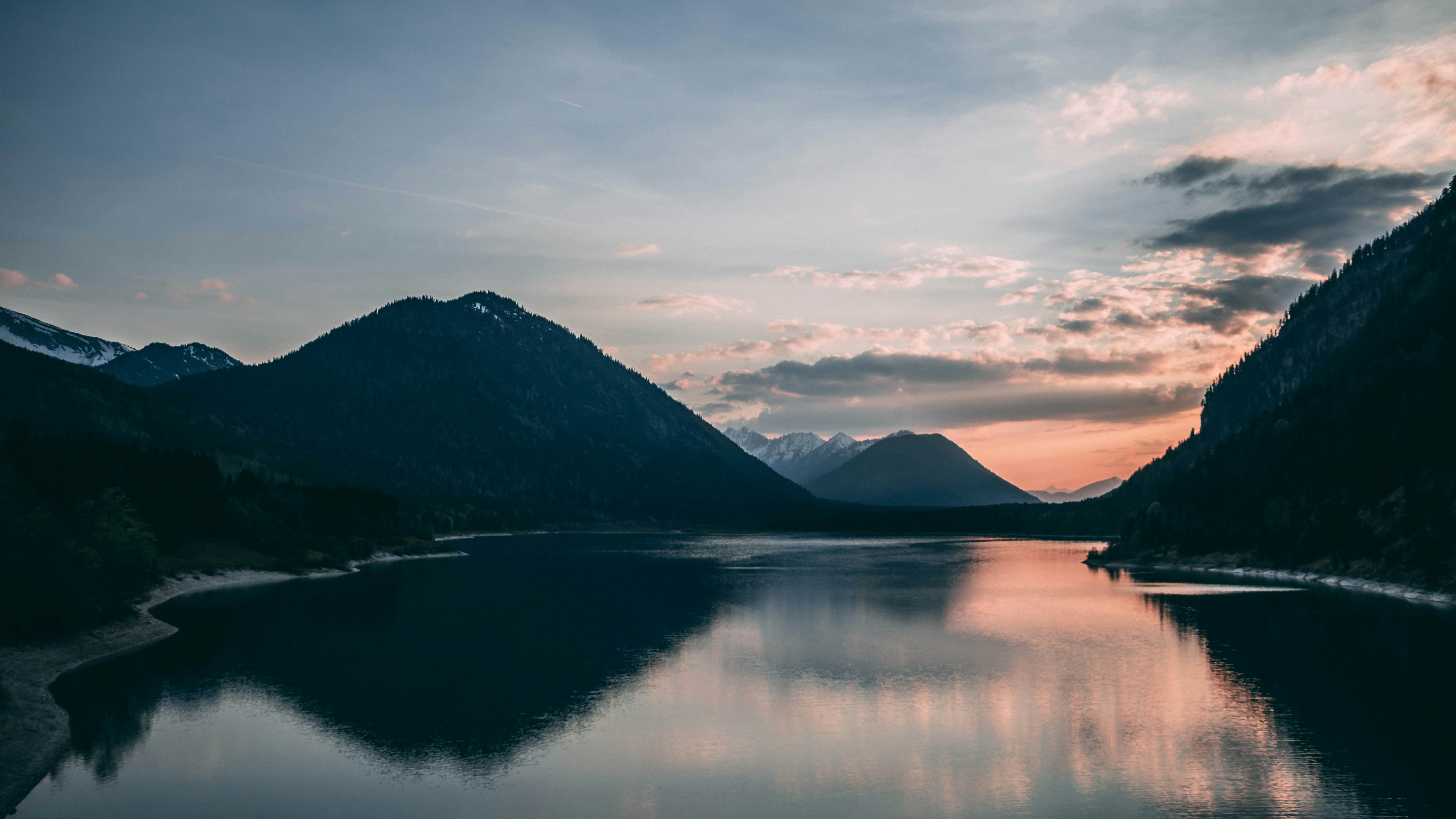 silhouette of mountain beside body of water